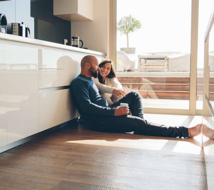 Couple sitting in floor of new apartment Couple sitting in floor of new apartment