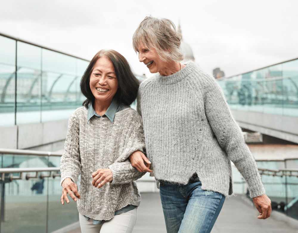 Women walking together talking-min