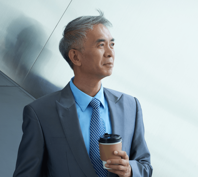 Man in suit drinking a coffee